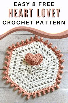 a crocheted doily with a pink heart on the center and white background