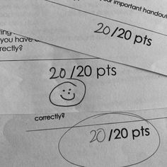 three sheets of paper with numbers and faces drawn on them, one has a smiley face