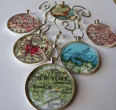 six pendants with different maps on them sitting next to each other, including the new york and brooklyn