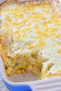 a casserole dish with corn and cheese on top, ready to be eaten