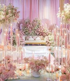 a room filled with lots of flowers and candles