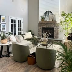 a living room filled with furniture and a fire place in the middle of a room