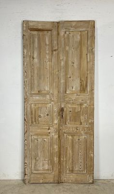 an old wooden double door in a room