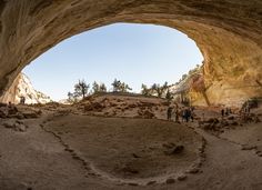 some people are standing in the middle of a cave