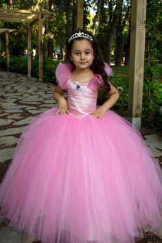 Here is our Rubies Pink Princess Dress, excellent for a Flower Girl! This fluffy court train rubies pink party gown is a great choice for toddler bridesmaid dress and junior wedding dress, as well as for pageants, birthdays, photo shootings and many other special occasions. It is made of dream tulle, crystal tulle, glitter printed crystal tulle, greek tulle and satin. It has a built-in petty coat for a fluffier look and embellished with bright rhinestone. The back of the tutu dress has lace-up s Princess Style Fitted Ball Gown For Dress-up, Pink Pageant Dress With Fitted Bodice, Pink Princess Gown For Debutante Ball, Pink Princess Style Pageant Dress With Fitted Bodice, Pink Fitted Floor-length Princess Dress, Pink Princess Dress With Fitted Bodice Ball Gown, Pink Ball Gown With Fitted Bodice For Debutante Ball, Pink Gown With Fitted Bodice For Debutante Ball, Pink Princess Dress With Fitted Bodice