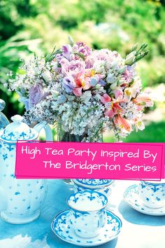 a table topped with blue and white dishes filled with flowers next to a pink sign that says high tea party inspired by the bridgerton series