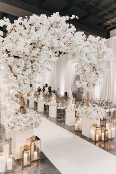 an elegant wedding setup with white flowers and candles