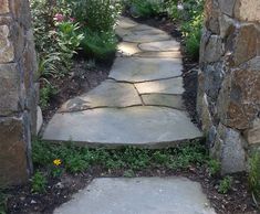 a stone path is shown through an archway