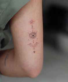 a woman's leg with an eye and stars tattoo on her left calf area