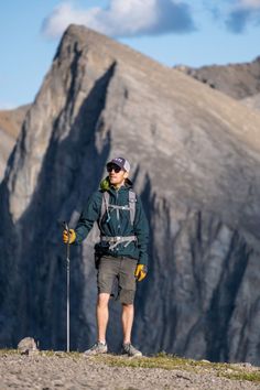 a man standing on top of a mountain holding ski poles