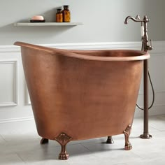 an old fashioned copper bathtub in a bathroom