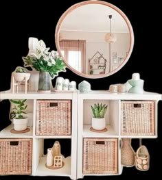 a white shelf topped with baskets under a mirror