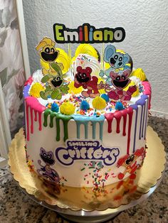 a birthday cake decorated with cartoon characters and sprinkles