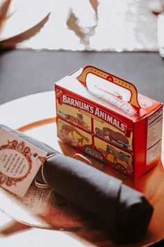 an open box of barnum's animals on top of a glass table next to a knife