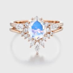 a ring with an oval blue topazte surrounded by white and rose cut diamonds