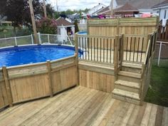 an above ground pool surrounded by wooden steps