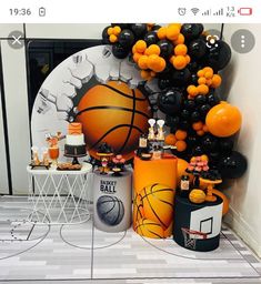 an orange and black basketball themed birthday party with balloons, confetti and decorations