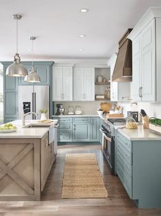 a kitchen with blue cabinets and an island in front of the counter top is shown