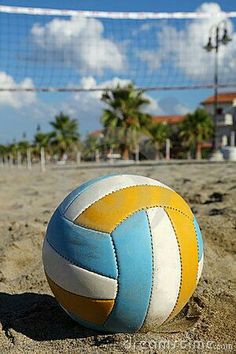 a beach volleyball ball sitting in the sand