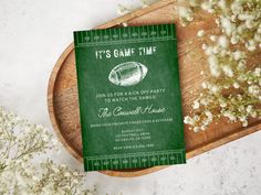 a football themed party card on a wooden platter