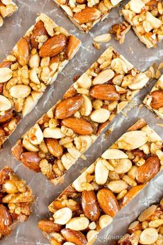 nuts and almonds are arranged in squares on a sheet of parchment paper, ready to be baked