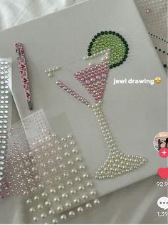 a card with pearls and beads next to a pair of scissors on top of it