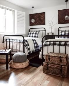 a bedroom with two twin beds and baskets on the floor