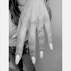 black and white photograph of a woman's hand with two rings on her fingers