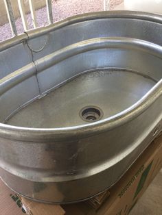 a large metal sink sitting on top of a box