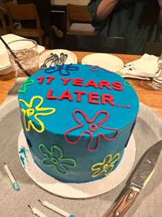 a blue birthday cake sitting on top of a table