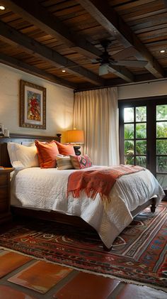 a bedroom with a large bed and lots of windows