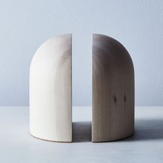 two white vases sitting next to each other on a table