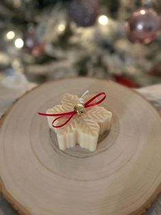 a small christmas ornament sitting on top of a piece of wood