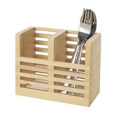 a fork and spoon are in a wooden holder with utensils inside the container