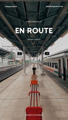 an empty train station with two benches on the platform and one bench in the middle