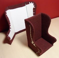 an open cardboard box sitting on top of a white table next to a red wall