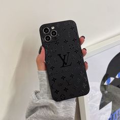 a person holding up a phone case with the louis vuitton logo on it