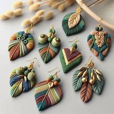 the earrings are made from polymer clay and have leaf designs on them, as well as beads