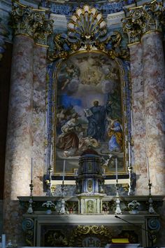 an ornate painting on the side of a wall above a fire place in a church