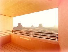 a balcony with a view of the desert and mountains in the backgrouds