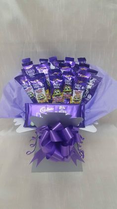 a bouquet of chocolates wrapped in purple ribbon