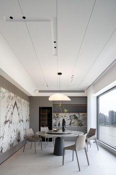 an elegant dining room with marble walls and white flooring is pictured in this image