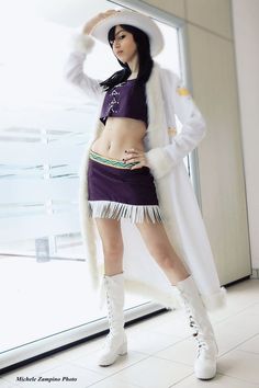 a woman in a purple outfit and white boots