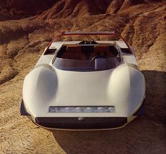 a futuristic car is parked in the desert