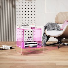 a living room with a chair, table and books on the floor in front of it