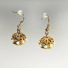 Filigree Ball Dangle Earrings, Faux Pearl, Gold Tone, French Hooks, Costume Jewelry, Collectible Enhance your ensemble with these stunning Filigree Ball Dangle Earrings. Crafted with intricate filigree detailing, these earrings boast a timeless appeal. Each earring features a ball adorned with eight faux pearls. The beauty of these earrings makes them suitable for both everyday wear and special occasions. Whether you're dressing up for a night out or adding a touch of glamour to your office atti Formal Baroque Filigree Earrings, Ornate Gold Filigree Plug Earrings, Elegant Filigree Baroque Earrings, Ornate Gold Pearl Earrings With Filigree, Yellow Gold Plated Filigree Chandelier Earrings, Costume Jewelry, Faux Pearl, Thoughtful Gifts, Everyday Wear