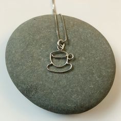 "This hand formed sterling silver pendant is a cup and saucer, perfect for anyone who loved coffee, tea, or cappuccino. This delicate pendant is 5/8\" tall including the bail and just over 1/2\" wide. The pendant is on a .85 mm wide sterling silver box chain. Please select the length chain you would like. The necklace will be shipped in a decorative cardboard jewelry box filled with an anti tarnish cotton. Sterling silver is a metal that can tarnish, storing it in the box in which it is shipped Coffee Bean Jewelry, Coffee Bean Necklace Gold, Simple Pearl Pendant, Tea Cup Necklace, Coffee Necklace, Silver Cat Pendant, Small Gold Hoops, Silver Cat Design Pendant Charm Necklace, Simple Pearl