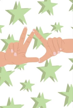 two hands reaching for each other in front of green stars