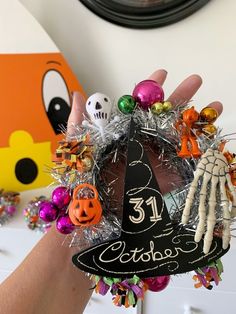 someone is holding up a halloween wreath with their hand on the top and number 31