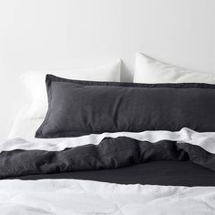 a black and white bed with two pillows